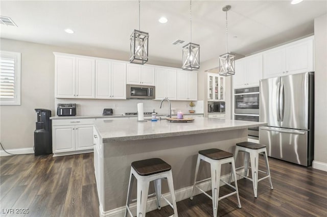 716 Cadence View Way, Henderson, NV 89011 - kitchen with stainless steel appliances, dark wood-style flooring, white cabinetry, baseboards, and recessed lighting