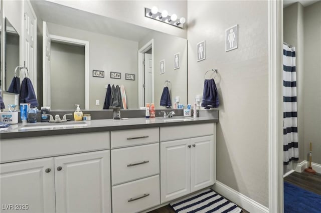 716 Cadence View Way, Henderson, NV 89011 - full bathroom featuring double vanity, baseboards, wood finished floors, and a shower with curtain