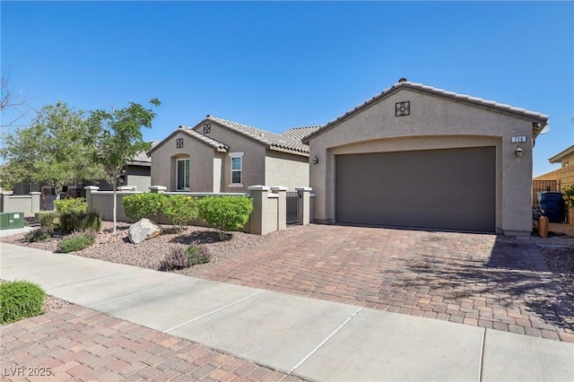 716 Cadence View Way, Henderson, NV 89011 - view of front facade featuring stucco siding, a tiled roof, decorative driveway, and a garage