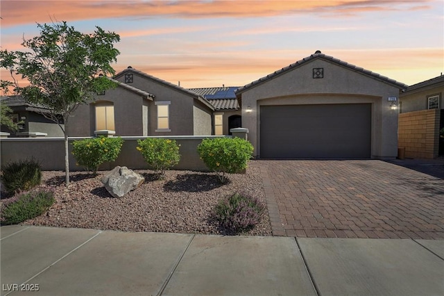 716 Cadence View Way, Henderson, NV 89011 - mediterranean / spanish-style house with stucco siding, roof mounted solar panels, decorative driveway, a garage, and a tile roof