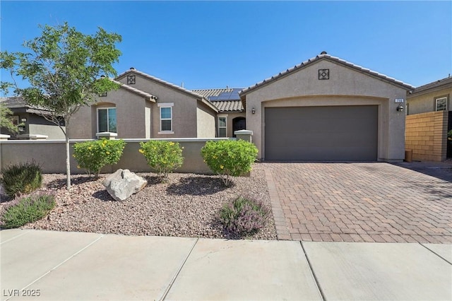 716 Cadence View Way, Henderson, NV 89011 - view of front of property featuring stucco siding, solar panels, decorative driveway, an attached garage, and a tile roof