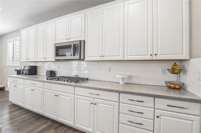 716 Cadence View Way, Henderson, NV 89011 - kitchen with stainless steel appliances, white cabinetry, and decorative backsplash