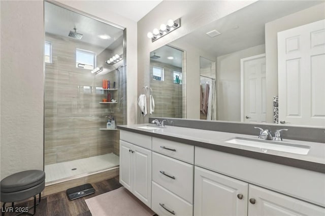 716 Cadence View Way, Henderson, NV 89011 - full bath with double vanity, a tile shower, and wood finished floors