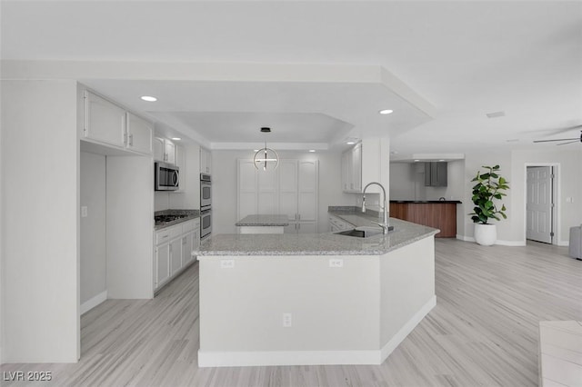 3604 N Campbell Rd, Las Vegas, NV 89129 - kitchen featuring a sink, appliances with stainless steel finishes, white cabinetry, recessed lighting, and baseboards