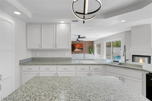 3604 N Campbell Rd, Las Vegas, NV 89129 - kitchen with a sink, white cabinetry, ceiling fan, recessed lighting, and light stone countertops