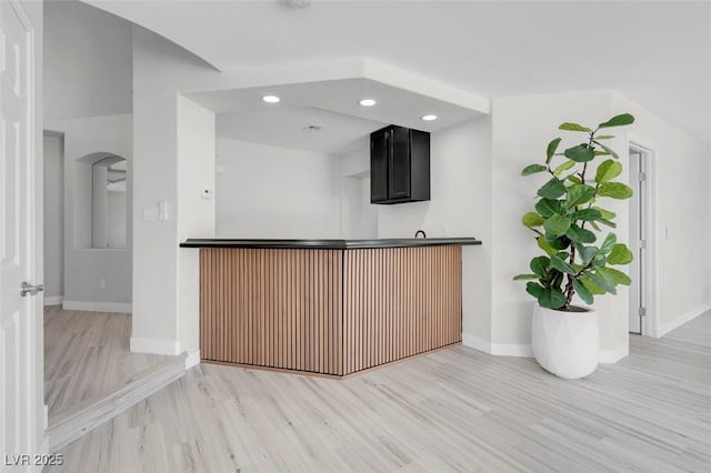 3604 N Campbell Rd, Las Vegas, NV 89129 - kitchen featuring light wood-style flooring, baseboards, dark cabinetry, recessed lighting, and arched walkways