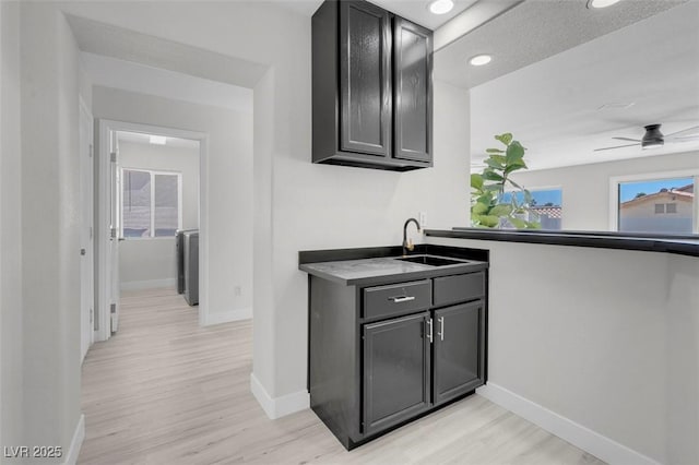3604 N Campbell Rd, Las Vegas, NV 89129 - bar featuring a sink, light wood-style floors, baseboards, ceiling fan, and recessed lighting