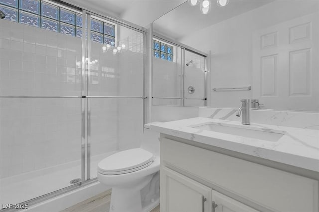 3604 N Campbell Rd, Las Vegas, NV 89129 - full bathroom featuring a shower stall, toilet, vanity, and wood finished floors