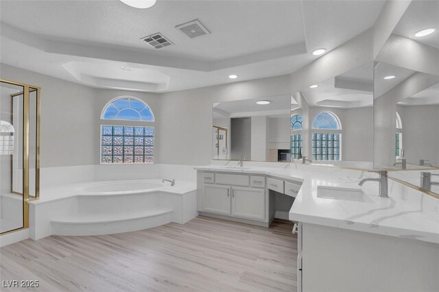 3604 N Campbell Rd, Las Vegas, NV 89129 - bathroom with a tray ceiling, a garden tub, plenty of natural light, vanity, and recessed lighting