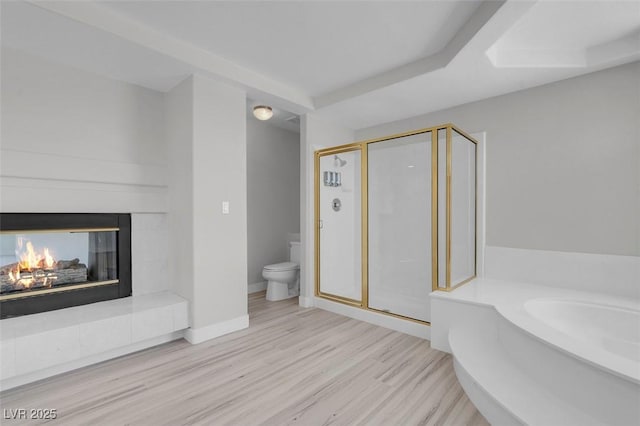 3604 N Campbell Rd, Las Vegas, NV 89129 - bathroom with a shower stall, a bath, wood finished floors, and a multi sided fireplace