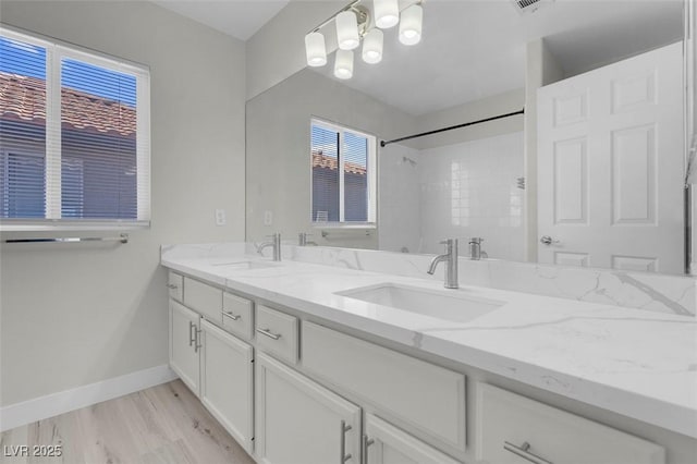 3604 N Campbell Rd, Las Vegas, NV 89129 - full bath with double vanity, baseboards, a shower, and wood finished floors