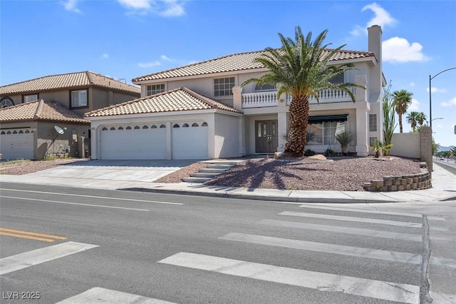 3604 N Campbell Rd, Las Vegas, NV 89129 - mediterranean / spanish-style house with a garage, stucco siding, concrete driveway, a tile roof, and a balcony