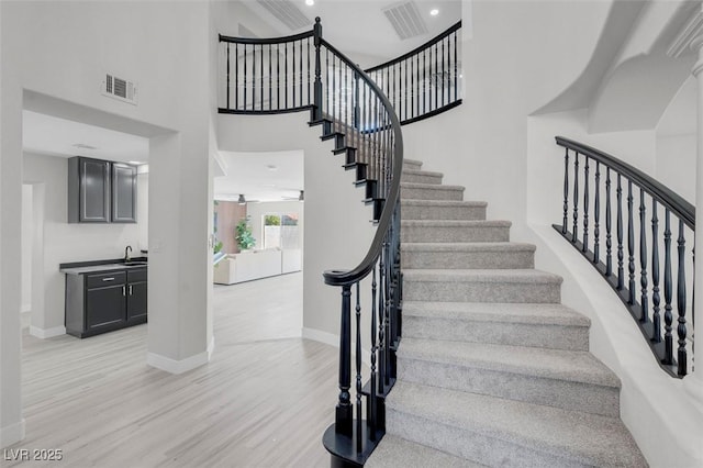 3604 N Campbell Rd, Las Vegas, NV 89129 - stairs featuring wood finished floors, baseboards, and a high ceiling