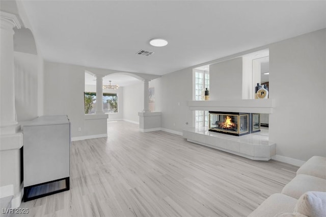 3604 N Campbell Rd, Las Vegas, NV 89129 - living area featuring decorative columns, wood finished floors, baseboards, and a tiled fireplace