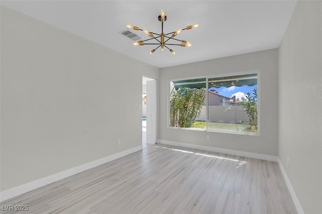 3604 N Campbell Rd, Las Vegas, NV 89129 - spare room with a chandelier and light wood finished floors