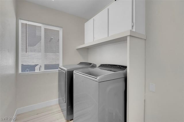 3604 N Campbell Rd, Las Vegas, NV 89129 - clothes washing area featuring independent washer and dryer, baseboards, light wood-style flooring, and cabinet space