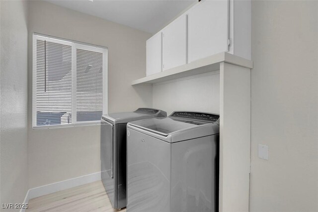 3604 N Campbell Rd, Las Vegas, NV 89129 - laundry room with independent washer and dryer, baseboards, light wood-type flooring, and cabinet space