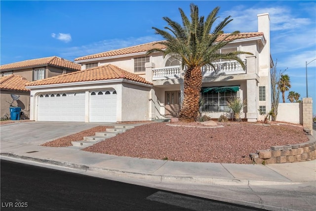 3604 N Campbell Rd, Las Vegas, NV 89129 - mediterranean / spanish-style house with a balcony, an attached garage, concrete driveway, and stucco siding