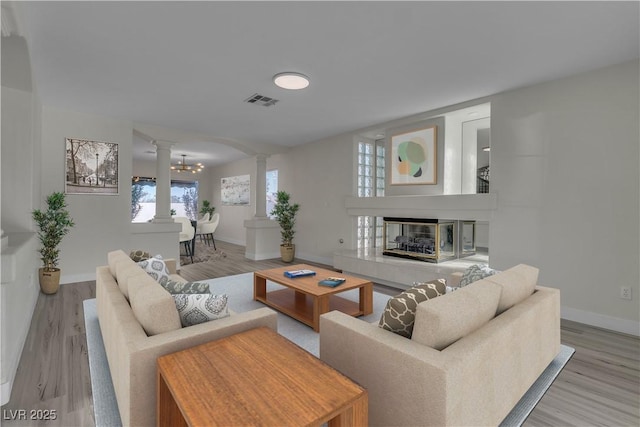 3604 N Campbell Rd, Las Vegas, NV 89129 - living area featuring decorative columns, baseboards, a glass covered fireplace, and wood finished floors