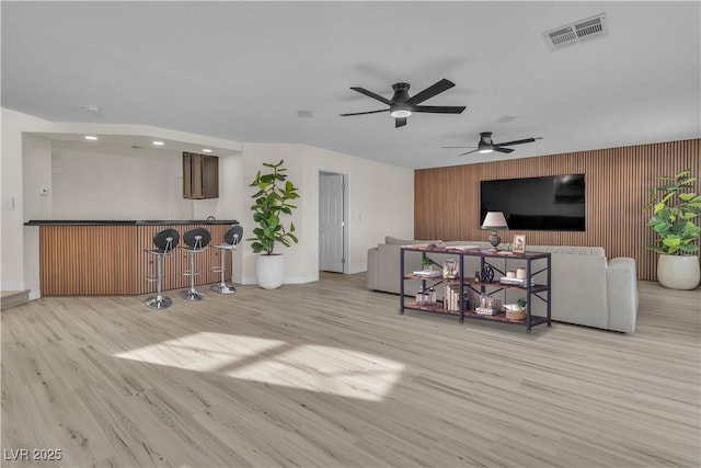 3604 N Campbell Rd, Las Vegas, NV 89129 - living room with a dry bar, wood finished floors, a ceiling fan, baseboards, and an accent wall