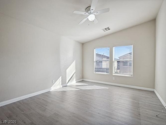 4675 Color Up Ct Unit 101, Las Vegas, NV 89122 - empty room with wood finished floors, ceiling fan, lofted ceiling, and baseboards