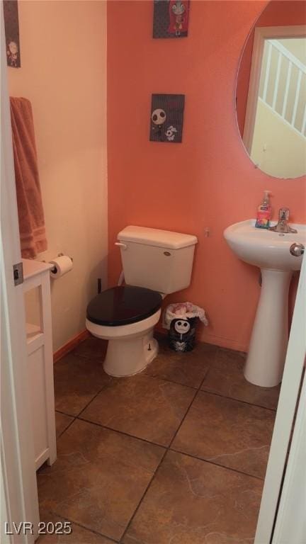 8913 Cambridge Glen Ct, Las Vegas, NV 89149 - bathroom with toilet, tile patterned flooring, a sink, and baseboards
