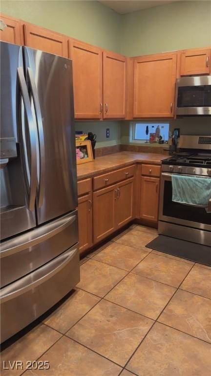 8913 Cambridge Glen Ct, Las Vegas, NV 89149 - kitchen with stainless steel appliances and light tile patterned floors