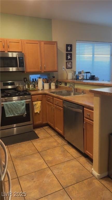 8913 Cambridge Glen Ct, Las Vegas, NV 89149 - kitchen featuring appliances with stainless steel finishes, a sink, and light tile patterned floors