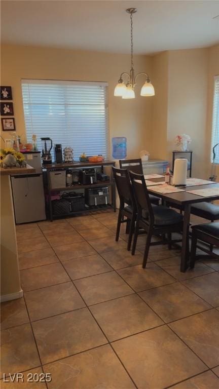 8913 Cambridge Glen Ct, Las Vegas, NV 89149 - dining space with light tile patterned flooring and a chandelier