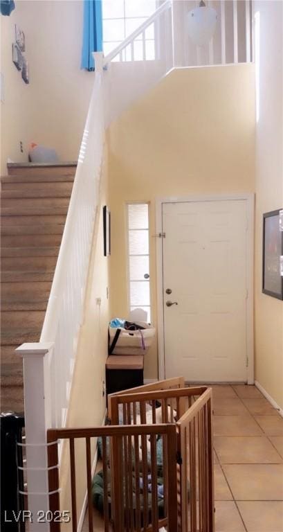 8913 Cambridge Glen Ct, Las Vegas, NV 89149 - staircase with a high ceiling and tile patterned floors
