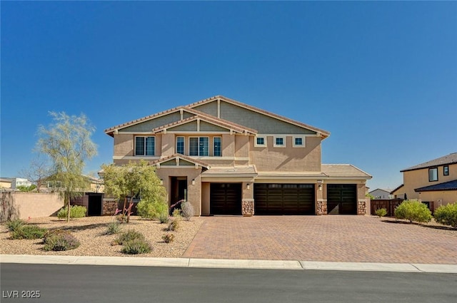 7572 Mount Spokane Ct, Las Vegas, NV 89113 - craftsman inspired home featuring stucco siding, fence, an attached garage, stone siding, and decorative driveway