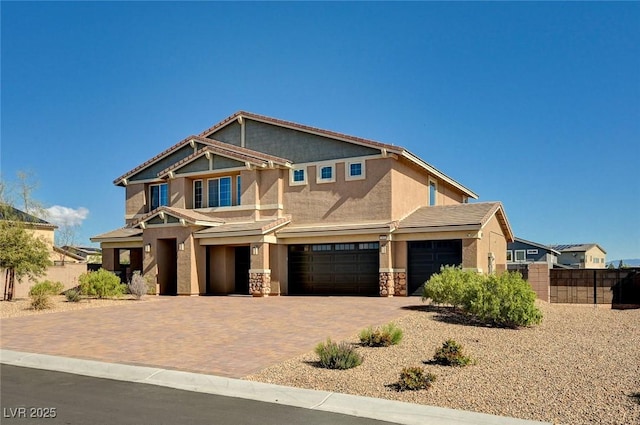 7572 Mount Spokane Ct, Las Vegas, NV 89113 - craftsman house featuring fence, stucco siding, a garage, stone siding, and decorative driveway