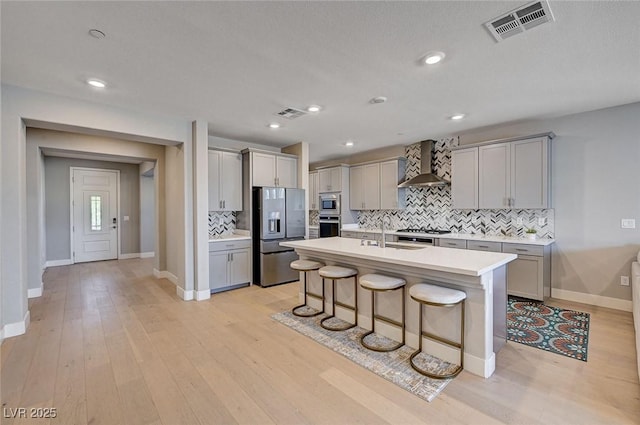 7572 Mount Spokane Ct, Las Vegas, NV 89113 - kitchen featuring appliances with stainless steel finishes, wall chimney range hood, gray cabinetry, a sink, and recessed lighting