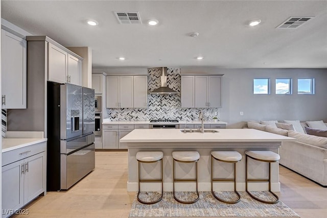 7572 Mount Spokane Ct, Las Vegas, NV 89113 - kitchen featuring stainless steel appliances, a sink, wall chimney range hood, gray cabinets, and recessed lighting