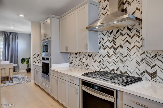 7572 Mount Spokane Ct, Las Vegas, NV 89113 - kitchen featuring stainless steel appliances, wall chimney range hood, tasteful backsplash, light countertops, and recessed lighting
