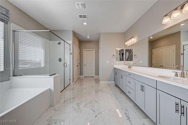 7572 Mount Spokane Ct, Las Vegas, NV 89113 - bathroom featuring marble finish floors, a bath, double vanity, a shower stall, and recessed lighting