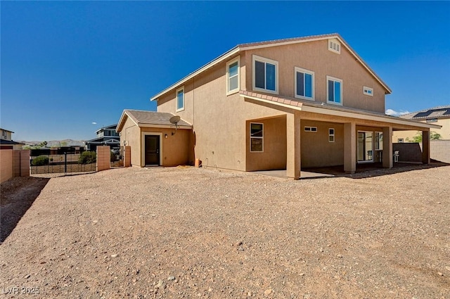 7572 Mount Spokane Ct, Las Vegas, NV 89113 - rear view of house featuring stucco siding, fence, and a gate