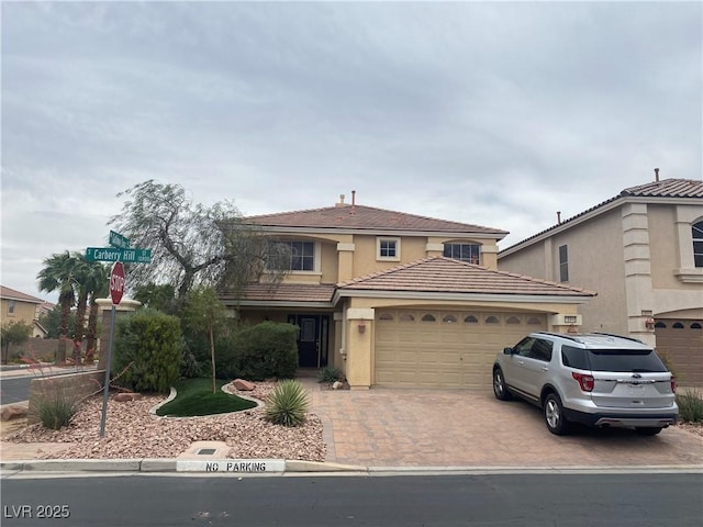 10948 Carberry Hill St, Las Vegas, NV 89141 - traditional-style home with a garage, driveway, a tiled roof, and stucco siding