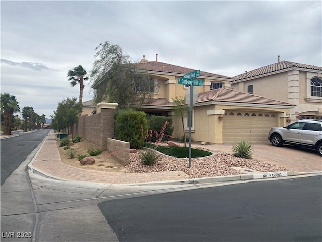 10948 Carberry Hill St, Las Vegas, NV 89141 - view of front of house featuring driveway, an attached garage, stucco siding, and a tiled roof