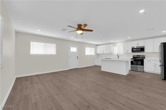 952 Balzar Ave, Las Vegas, NV 89106 - kitchen with stainless steel appliances, open floor plan, light wood-style flooring, recessed lighting, and ceiling fan