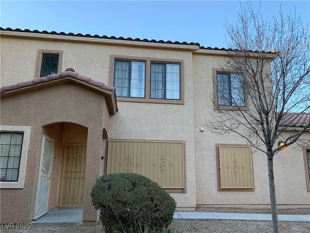 2121 Hussium Hills St Unit 107, Las Vegas, NV 89108 - view of front of home featuring stucco siding and a tiled roof
