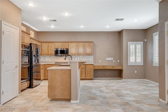 10608 Trussell St, Las Vegas, NV 89141 - kitchen with stainless steel microwave, light countertops, decorative backsplash, stone finish floors, and light brown cabinetry