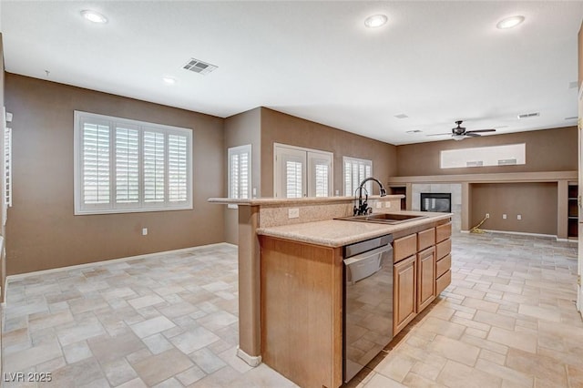 10608 Trussell St, Las Vegas, NV 89141 - kitchen featuring stainless steel dishwasher, open floor plan, a fireplace, light stone finish floors, and recessed lighting