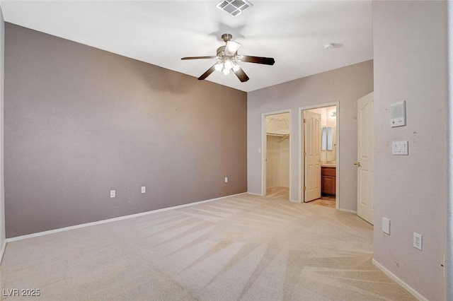 10608 Trussell St, Las Vegas, NV 89141 - unfurnished bedroom featuring light colored carpet, a spacious closet, ceiling fan, and a closet