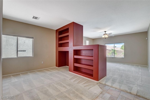 10608 Trussell St, Las Vegas, NV 89141 - spare room with built in shelves, light colored carpet, and ceiling fan