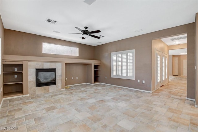 10608 Trussell St, Las Vegas, NV 89141 - unfurnished living room with light stone finish flooring, a tile fireplace, and ceiling fan