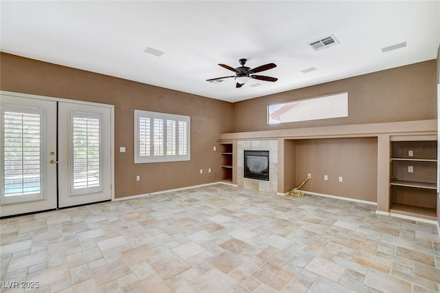10608 Trussell St, Las Vegas, NV 89141 - unfurnished living room with ceiling fan, built in shelves, and light stone finish flooring