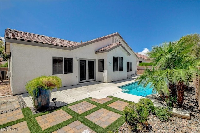 10608 Trussell St, Las Vegas, NV 89141 - rear view of house with a tiled roof, an outdoor pool, a patio area, and stucco siding