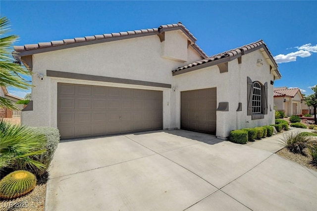 10608 Trussell St, Las Vegas, NV 89141 - view of front facade featuring stucco siding, a garage, concrete driveway, and a tile roof