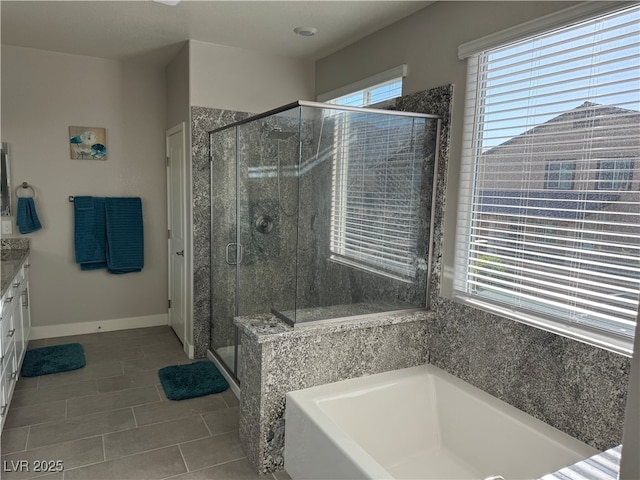 7855 Skyler Falls Ln, North Las Vegas, NV 89084 - bathroom with a garden tub, a stall shower, tile patterned floors, vanity, and baseboards
